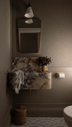 a bathroom with a sink, toilet and mirror in it's corner area next to a rug on the floor