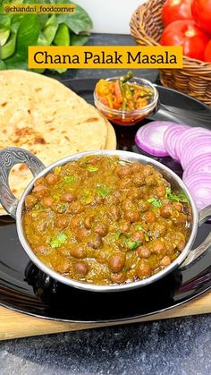 chana palak masala served on a black plate