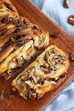 sliced pecan bread on a cutting board with nuts and cinnamons around the edges