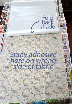 an advertisement is displayed on the side of a table covered in fabric and newspaper clippings