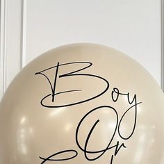 a white balloon with the words boy or girl written on it and a black marker