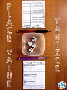 two dices are in a plastic container with some writing on the table next to it