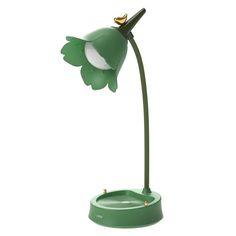 a green lamp with a bird on it's head in the shape of a flower