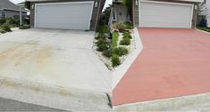 two garages side by side in front of each other with grass growing on the driveway