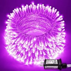 purple christmas lights are lit up in the shape of a circle on a purple background