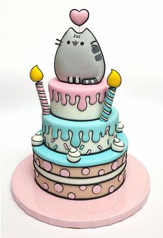 a cake with a cat sitting on top of it