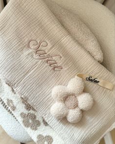 a white towel sitting on top of a chair next to a tag with the word coco written on it