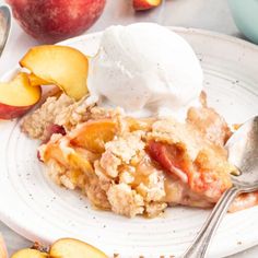 a white plate topped with an apple crisp and ice cream next to sliced peaches