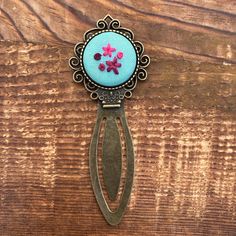 a pair of scissors sitting on top of a wooden table with flowers in the center