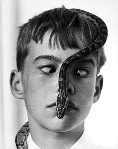 a boy with a snake on his nose