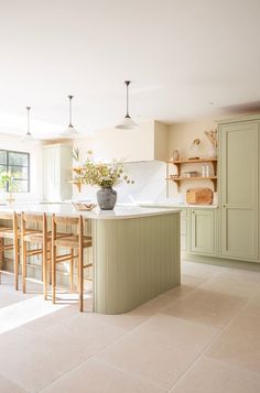 a large kitchen with an island in the middle