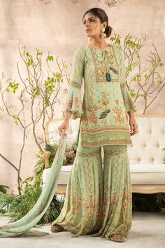 Mint green kurta with all-over floral print, delicate embroidery, notched neckline and flared sleeves. Comes with sharara and dupatta.
Component: 3
Printed, Embroidered
Neckline: Round
Sleeve Length: Full
Fabric: Georgette
Color: Green
Straight kurta
Notched round neckline
Printed sharara and dupatta - Aza Fashions Printed Sharara, Mustard Skirt, Mehendi Outfit, Mehndi Outfits, Sharara Designs, Mehendi Outfits, Girls Attire, Desi Girl, Sharara Set