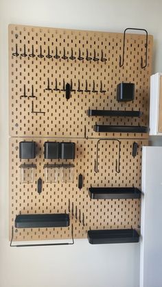 a peg board with some black objects on it