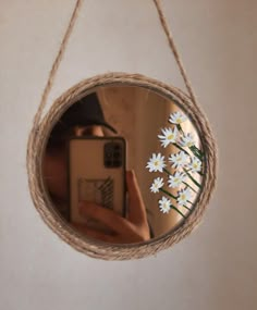 a person taking a selfie in front of a mirror with daisies on it