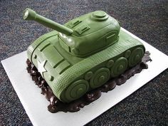 a cake shaped like a tank sitting on top of a table