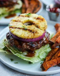 a plate with a burger and some fries on the side next to eachother