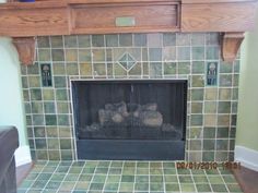 a fireplace in a living room with green tile