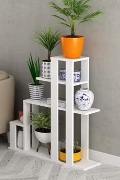 three white shelves with plants and vases on them