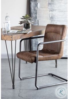 a brown chair sitting next to a wooden table with a plant on top of it