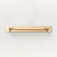 an image of a gold door handle on a white wall