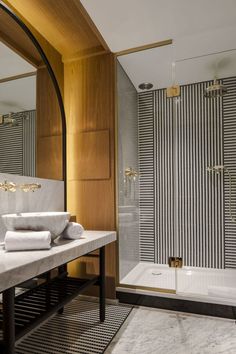 a bathroom with a sink, mirror and shower stall in it's own area