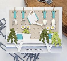 a card with flowers and gardening utensils on it