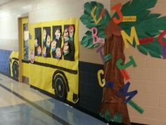 a school bus decorated with paper and cut out letters on the side of the wall