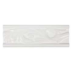 a white wall tile with an ornate design