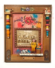 a wooden frame with an old photo and some beads