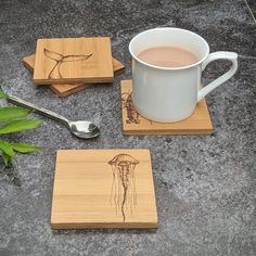 a cup of coffee next to some coasters