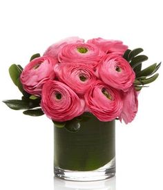 a vase filled with pink flowers on top of a table