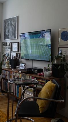 a living room filled with furniture and a flat screen tv mounted to the side of a wall