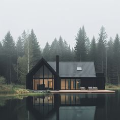 a house sitting on top of a lake next to a forest filled with lots of trees