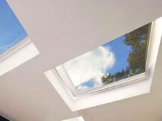 a bedroom with three skylights on the ceiling