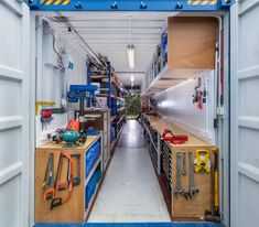 the inside of a large storage container with tools and equipment on it's shelves