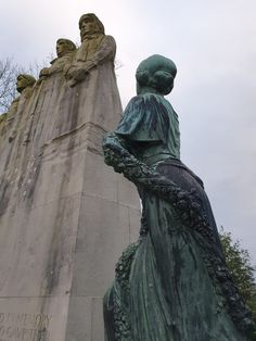 there is a statue in front of a tall building