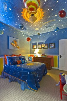 this is a bedroom with blue and yellow walls, stars on the ceiling, and a bed