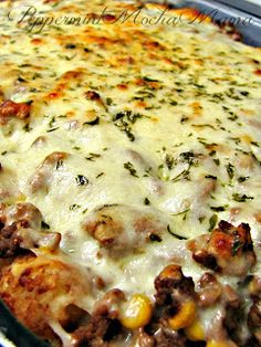 a cheesy casserole with meat, cheese and vegetables is shown here