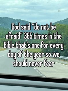 a car driving down a road with the words god said do not be afraid 350 times in