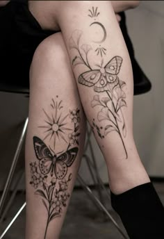 a woman's legs with butterflies and flowers tattoo on her leg, sitting next to a chair