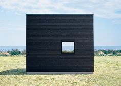 a black building with a small window in it