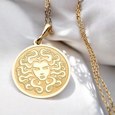 Discover the enchanting allure of our 14K Solid Gold Medusa Necklace, a handmade charm inspired by Greek mythology. This tiny Medusa coin necklace features a minimalist design that beautifully captures the essence of this legendary figure, making it a perfect statement piece for any jewelry collection. 🌼 Handmade Necklace - Made to order 🌼 Colors: Silver / Gold / Rose Gold 🌼 Materials: 925 Sterling Silver / 14K Solid Gold / 14K Gold Plated FAQ: ✈️Express and Free Shipping. ⏱️ Items will be sh Medusa Necklace, Tiny Necklace, 14k Gold Necklace, Necklace Minimalist, Pet Necklace, Handmade Charms, Coin Necklace, Minimalist Necklace, Gold Plated Necklace