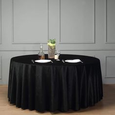 a round table with two plates on it and a pineapple centerpiece in the middle