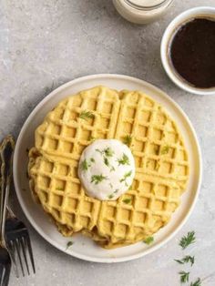 two waffles on a plate next to coffee