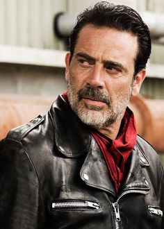 a man wearing a black leather jacket and red shirt