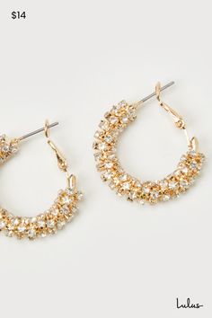 You'll always have a chic air about you when you wear the Lulus Sophisticated Glow Gold Rhinestone Hoop Earrings! Shiny, gold-toned metal shapes these elevated earrings that put a glittery new twist on a classic style, with sparkling rhinestones sprinkled across the rounded profiles of these iconic hoops. Post backs. 1" Diameter. 25% Brass, 40% Steel, 35% Glass. Imported. Lulus | Sophisticated Glow Gold Rhinestone Hoop Earrings. Gold Hoop Crystal Earrings For Party, Gold Metal Hoop Earrings With Sparkling Stones, Gold Metal Hoop Crystal Earrings, Gold-tone Hoop Earrings For Party, Gold Hoop Crystal Earrings, Gold Small Hoop Crystal Earrings, Gold Sparkling Hoop Earrings, Rhinestone Hoop Earrings, Lulu Fashion