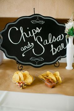 chips and salsa bar sign next to some tacos