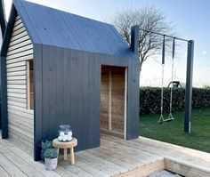 a small wooden building sitting on top of a wooden deck