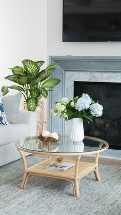 a living room with a couch, coffee table and television