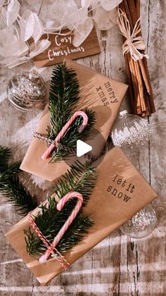 some candy canes and cinnamon sticks on top of brown envelopes